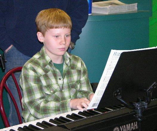 dylanplaying.jpg - My Grand/Son Dylan Clark playing the piano during a recital held at Martin's Supermarket. December 9, 2006.