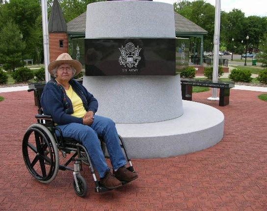 sandyvetmem.jpg - Sandy sitting by the Veterans Memorial at Riverfront Park in Niles, Michigan. It was a cold day for June 17, 2005.